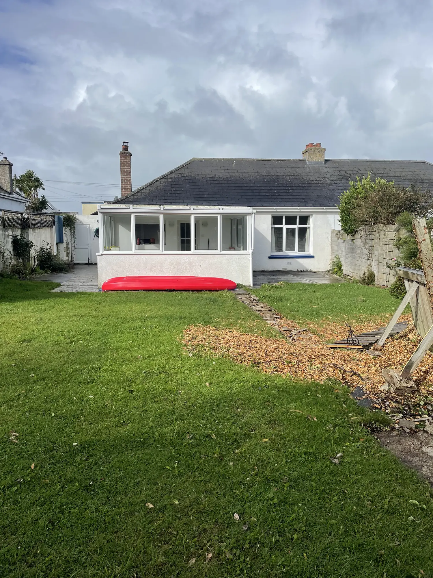 Rear of the white bungalow and garden before renovation and extension work